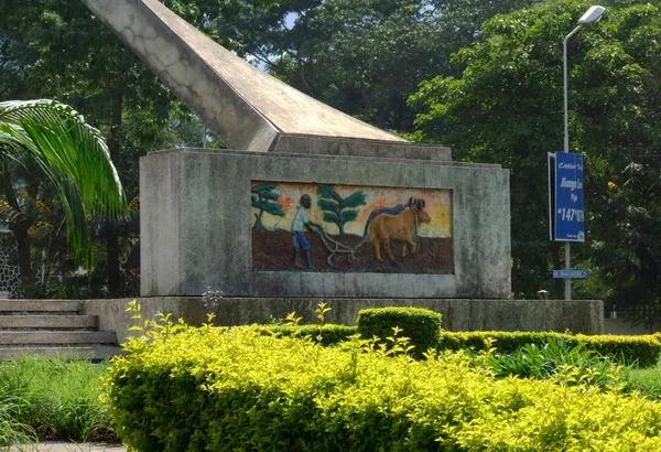 Another mural on the monument's base, showing a farmer ploughing with an ox.