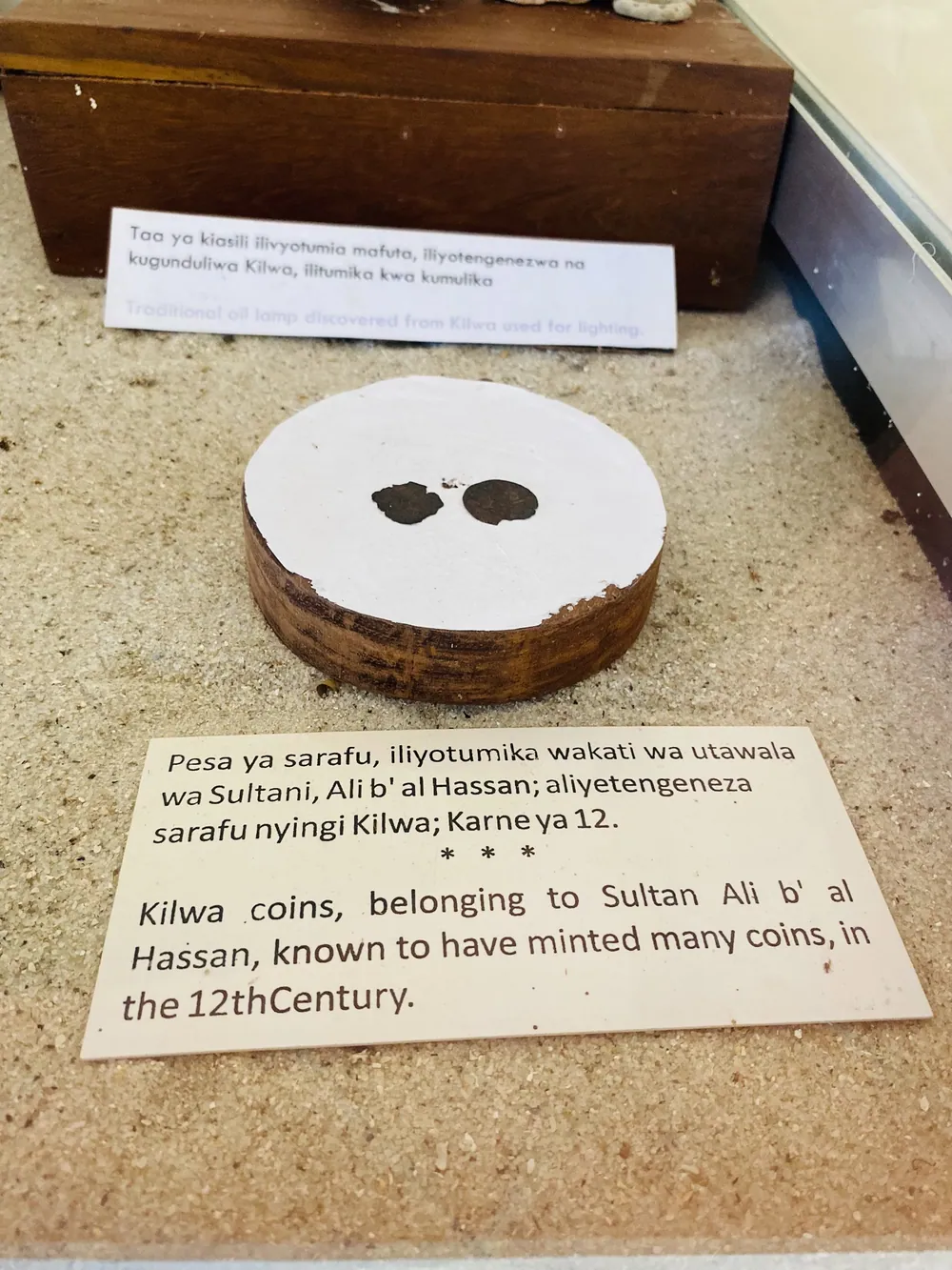 A Kilwa coin on show at the site, its label crediting it to the reign of Sultan Ali bin al-Hassan.