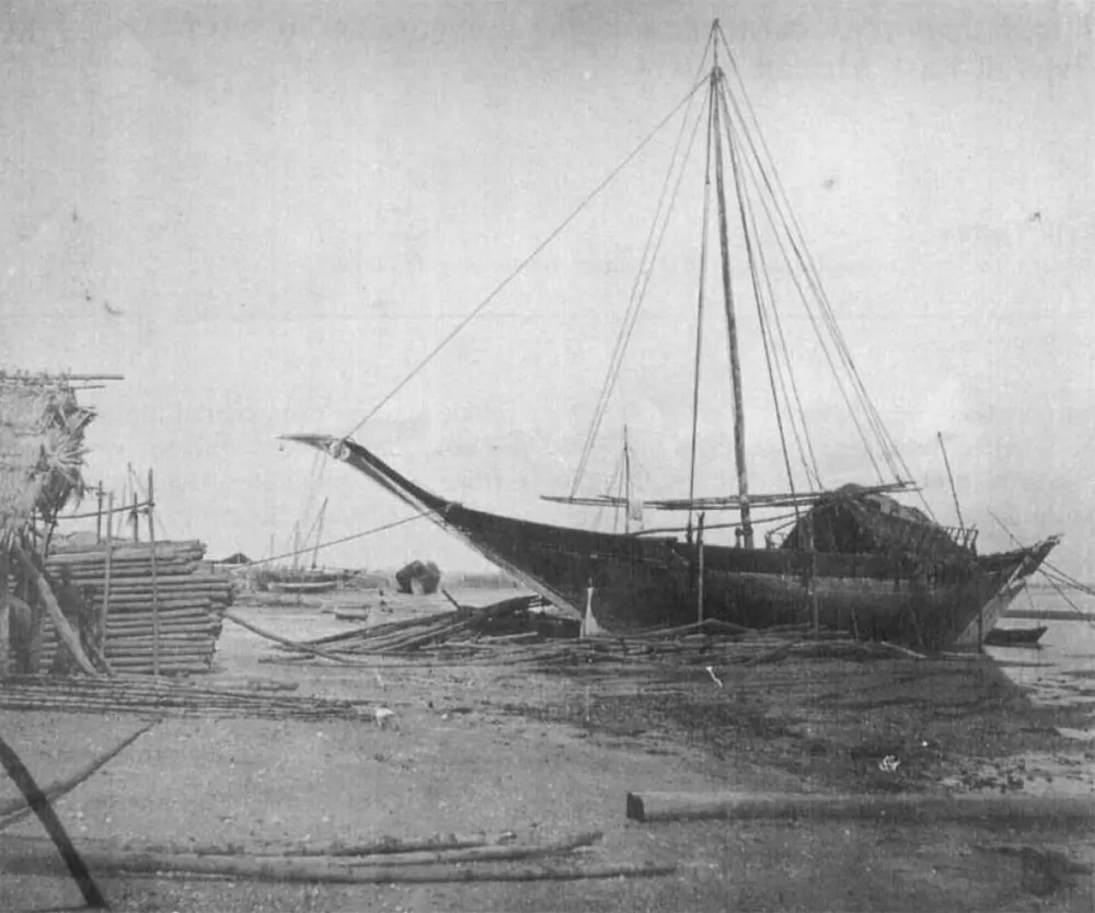A sewn wooden mtepe boat drawn up on the beach at Zanzibar, around 1890