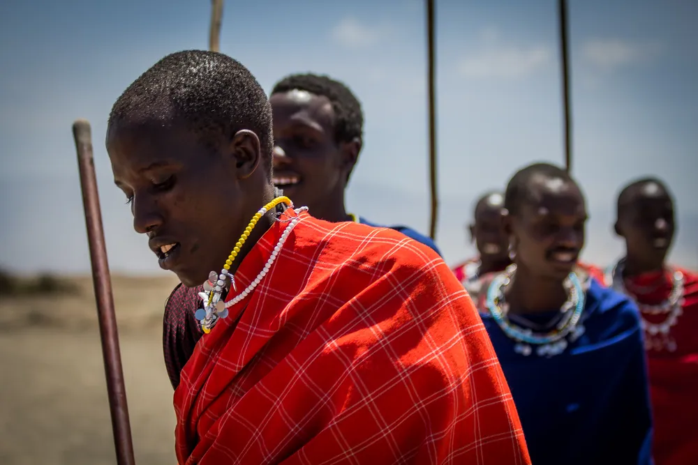 Maasai dancers in red shukas gathered on the plains