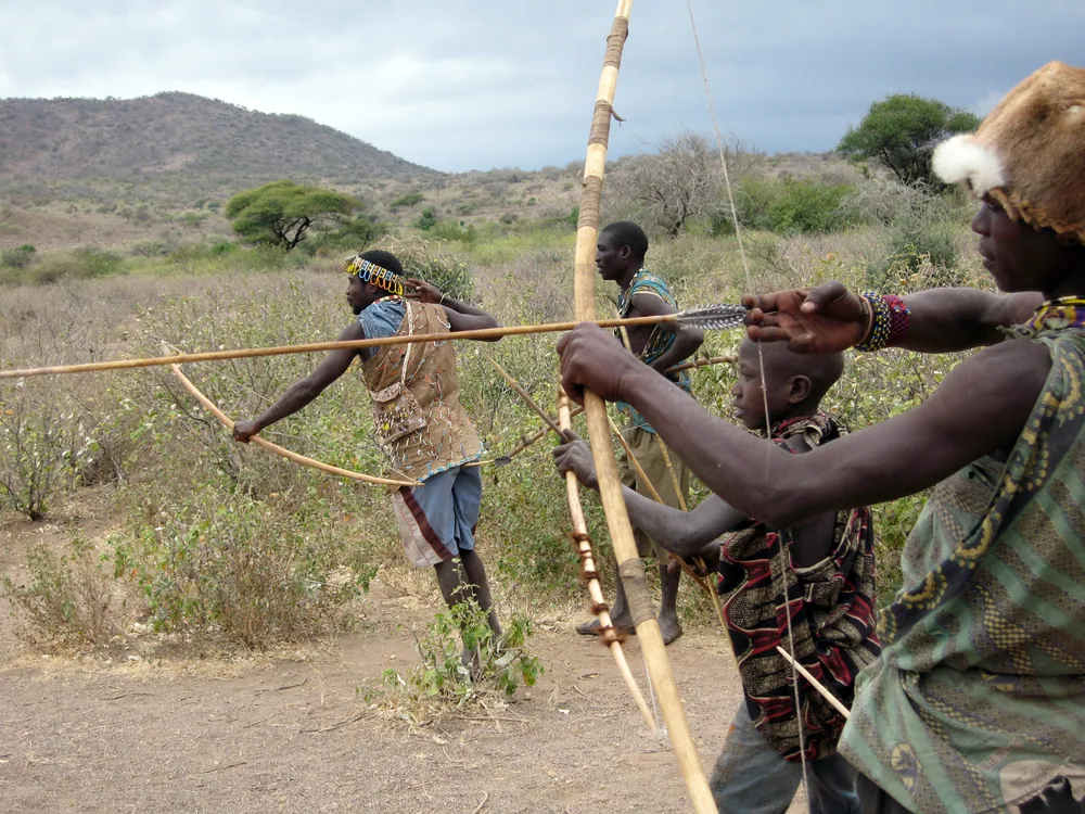 Hadza hunters with bows near Lake Eyasi