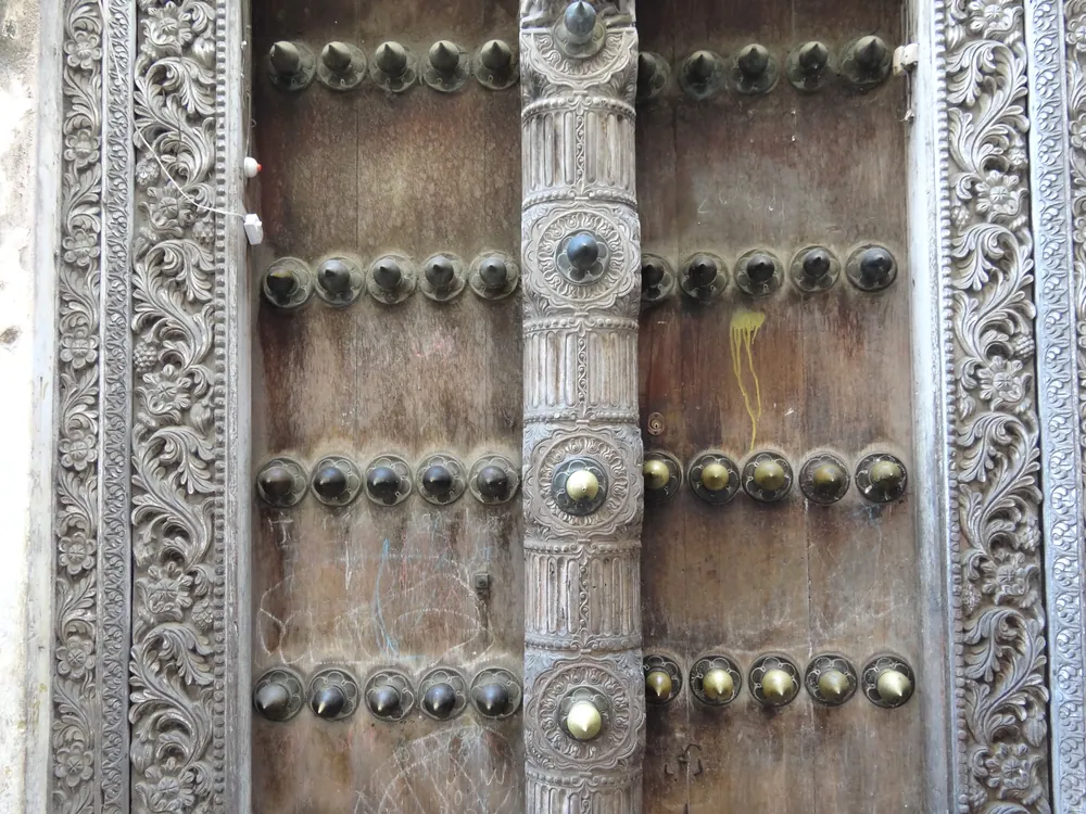Detail of a carved and brass-studded Zanzibari door in Stone Town